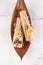Vertical image of palo santo sticks with bouquets of dried flowers on white marble table background