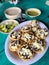 Vertical image with a plate of Sopes accompanied by sauces in the restaurant