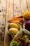 Vertical image of raw vegetables and organic vegetable waste in kitchen composting bin