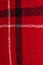 Vertical image of red checkered textured woolen background