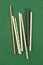 Vertical image with set of different drinking paper straws on green background. Biodegradable drinking straws