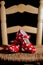 Vertical image of some traditional Spanish shoes on a typical flamenco tablao chair, using artificial lighting