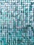 Vertical image of square blue sequined fabric texture - shiny green sparkling sequins background. Festive, carnival or fashion