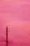 Vertical Image of Telecommunication Tower Against Dreamy Pink Cloudy Sky