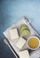 Vertical image of three lemon cake slices with limes and honey