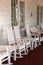 Vertical image of white rocking chair on country porch