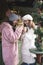 Vertical image of women on Christmas market drinking mulled wine