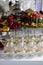 Vertical images of alcoholic cocktails on festive table with watermelon, grape, pitahaya, carambola, banana