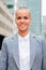 Vertical individual portrait of a businesswoman smiling and looking at camera with proud expression. Clerk, agent