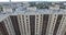 A vertical inspection of a big modern residential building against the urbanscape