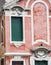 Vertical: Intricate art, sculptures, and ironwork adorn the historic buildings in Venice, Italy.