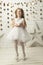Vertical joyful little girl in an elegant dress