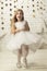 Vertical joyful little girl in an elegant dress