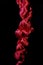 Vertical knotted up silky red cord on black isolated background, stressful concept - end of rope