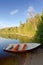 Vertical lake landscape with red rowboat