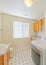 Vertical Laundry and bathroom combination interior with patterned tiles and shelving units