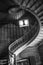 Vertical low angle grayscale shot of a staircase in an ancient building