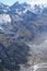 Vertical low-angle of misty, ridged mountain covered with snow