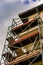 Vertical low angle shot of a building with a scaffolding metal frame under a cloudy sky