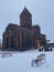 Vertical low angle shot of a magnificent church captured on a snowy day