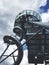 Vertical low angle shot of a metal building spiral stairs under a cloudy sky