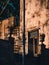 Vertical low angle shot of a old building with old  window, old staircase and two large vases