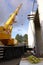 Vertical low angle shot of a tall mobile crane on a construction site