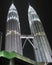 Vertical low angle shot of two beautiful lighted towers at night