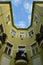 Vertical low angle shot of yellow residential building under blue sky and white clouds