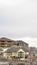 Vertical Luxurious multi storey homes on a snow covered mountain under overcast sky