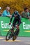 Vertical of a man riding a bicycle down a lane during a competition