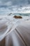 A vertical moody seascape photographed on a cloudy, stormy day