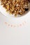 Vertical Morning text stamped under bowl of fresh cereal and mil