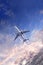 Vertical nature background with aircraft and Jet trailing smoke in sunset sky. Airplane and condensation trail