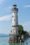 Vertical of the New Lindau Lighthouse captured against a blue sky in Lindau, Germany