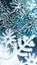 Vertical New Year`s photo of snowflakes, spruce branches in the snow. Beautiful snow-covered festive scenery 2021