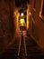 Vertical night view of alleyway stairs going down through graffitied buildings