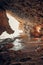 Vertical of ocean waves approaching a coastal cave and rock formations