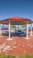 Vertical Octagon shaped picnic pavilion with view of colorful playground and scenic lake