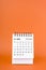 Vertical of October 2024 table calendar on orange background