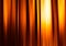 Vertical orange motion blur curtains with glow background