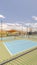 Vertical Outdoor tennis courts and sunny recreational park