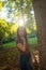 Vertical outdoors lifestyle portrait of young happy and beautiful Asian Korean woman enjoying relaxed and cheerful at city park in