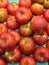 Vertical overhead view of bright red fresh apples on a light blue background