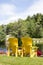 Vertical pair of yellow muskoka chairs at lake