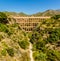 A vertical panorama of the majestic, four storey, Eagle Aqueduct that spans the ravine of Cazadores near Nerja, Spain