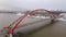 Vertical panorama of the red bridge. Aerial photography in 4k. Bugrinsky bridge in the Novosibirsk region