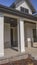 Vertical Pathway and stairs leading to the porch with pillars at the facade of a home