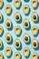 Vertical pattern of cut avocado on blue background