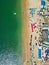 Vertical Perspective: Aerial View of Beach Umbrellas, Ocean, and Nearby Hotels